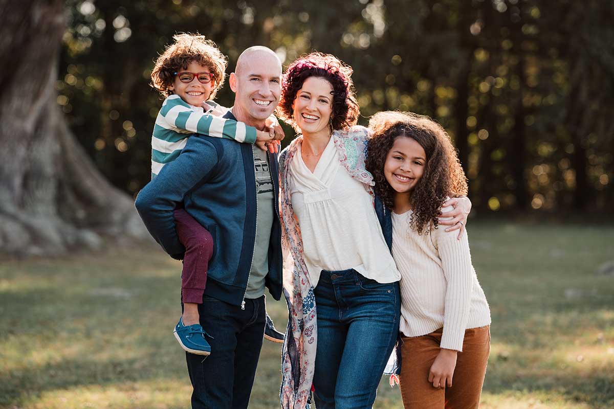 two parents and two children in a family photo